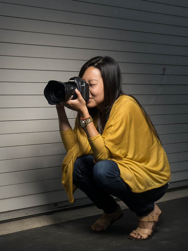 Incorrect crouching position with photographer on the balls of their feet creating an unstable base for handheld camera work