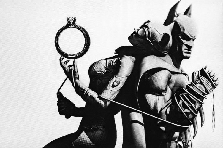 Wedding rings displayed with DC Comics memorabilia reflecting couple's shared interest