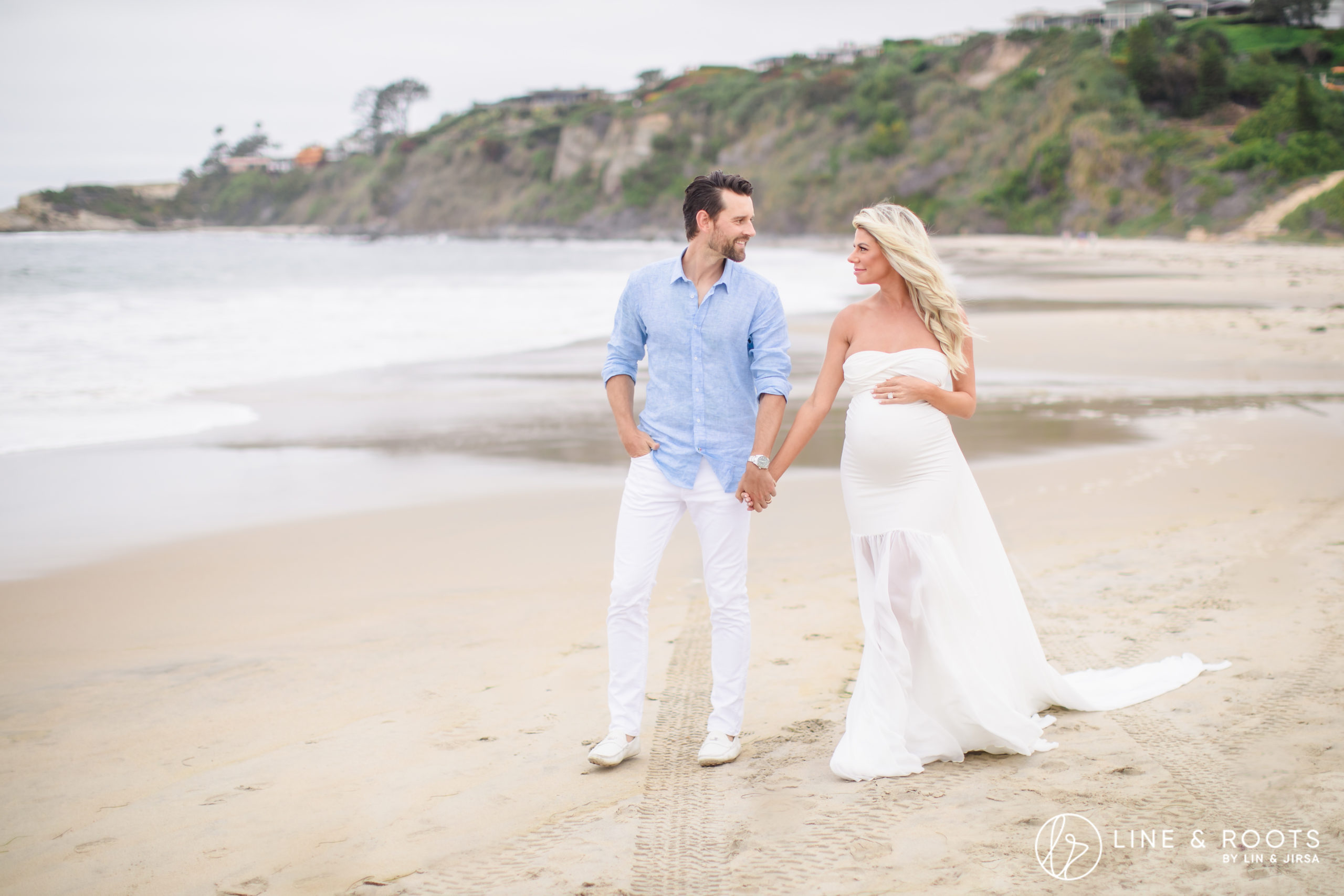 couple maternity photoshoot ideas with couple walking the beach