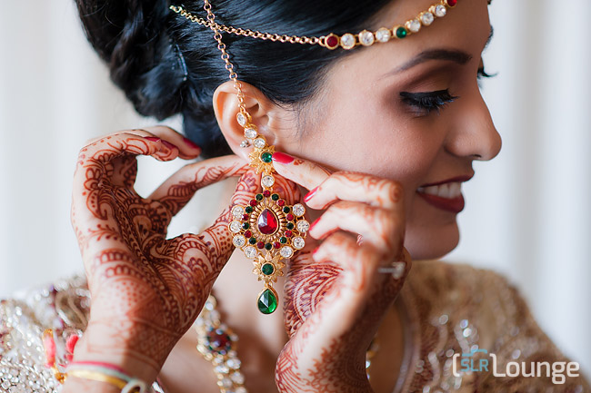 Camera LCD playback showing 100 percent zoom on portrait earring detail demonstrating how to evaluate precise focus on an off-center subject