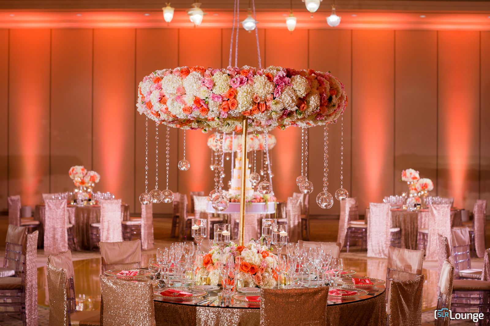 Reception table detail photography showing centerpiece arrangement, place settings, and ambient lighting captured before guests are seated