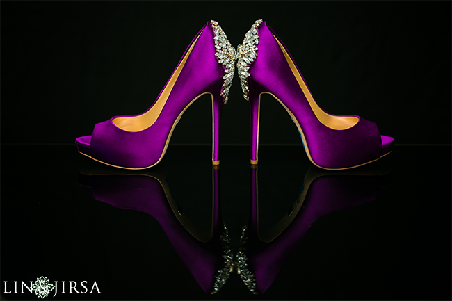 Wedding shoes detail shot with heels positioned sole to sole on a reflective marble surface with soft window light for bridal detail photography